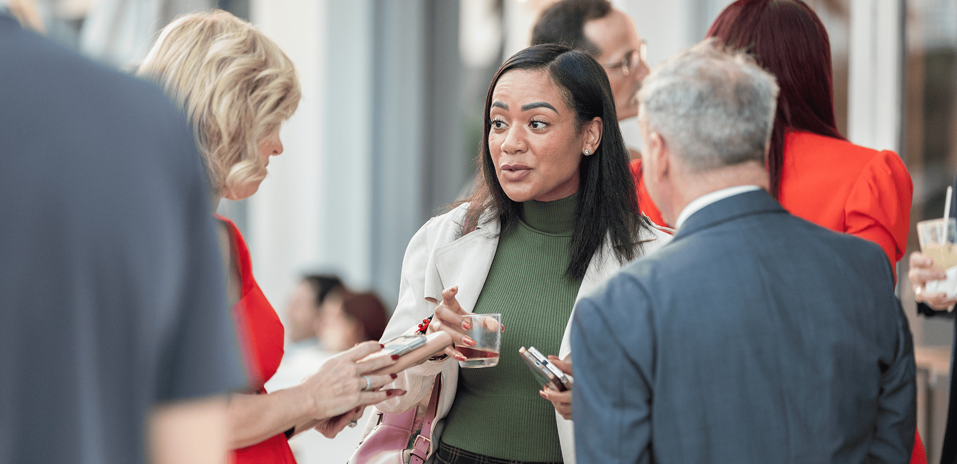 Attendees networking at a legal event while holding a drink